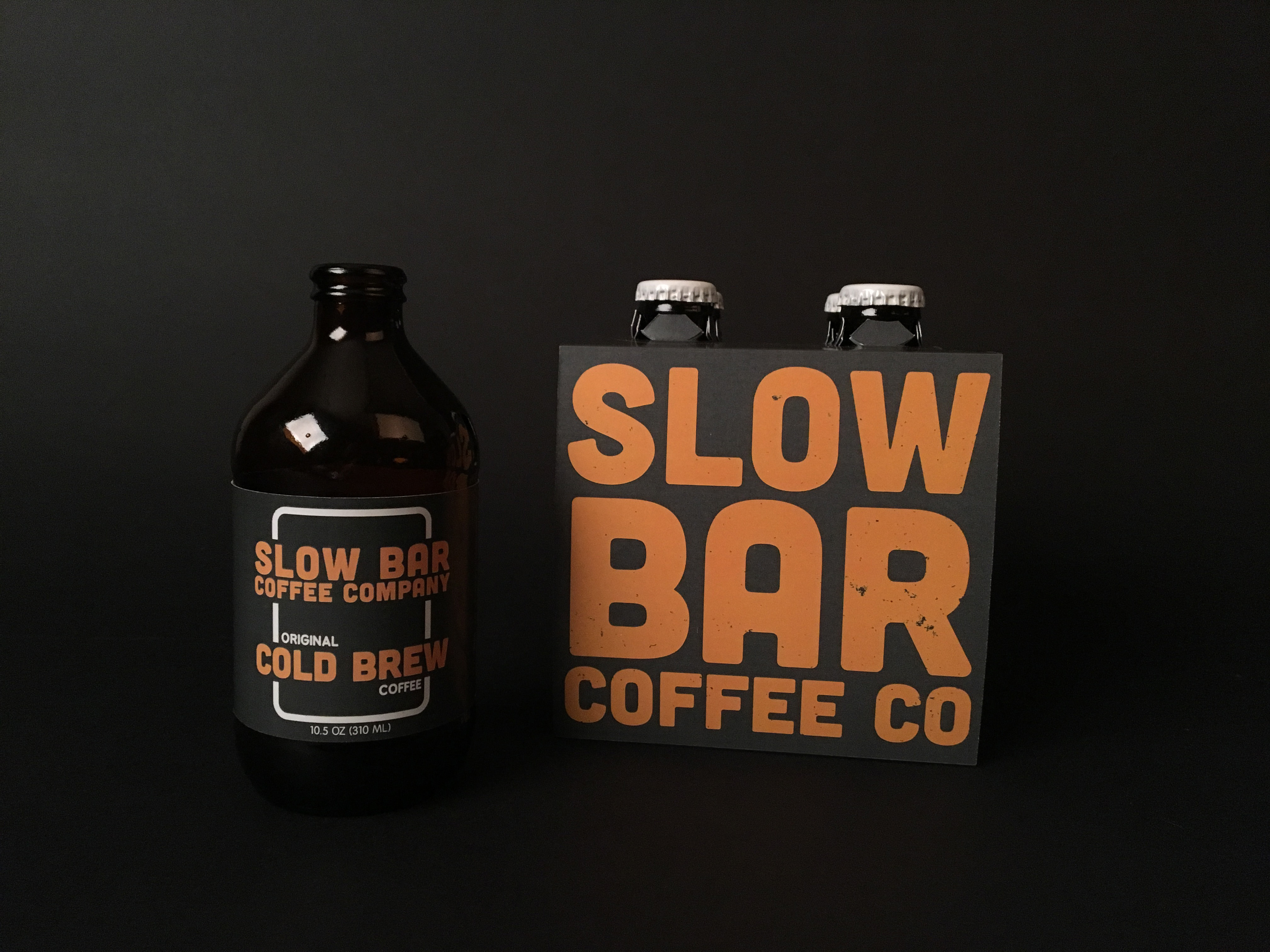 Bottle and package of 4 Slow Bar Coffee Company's cold brew.