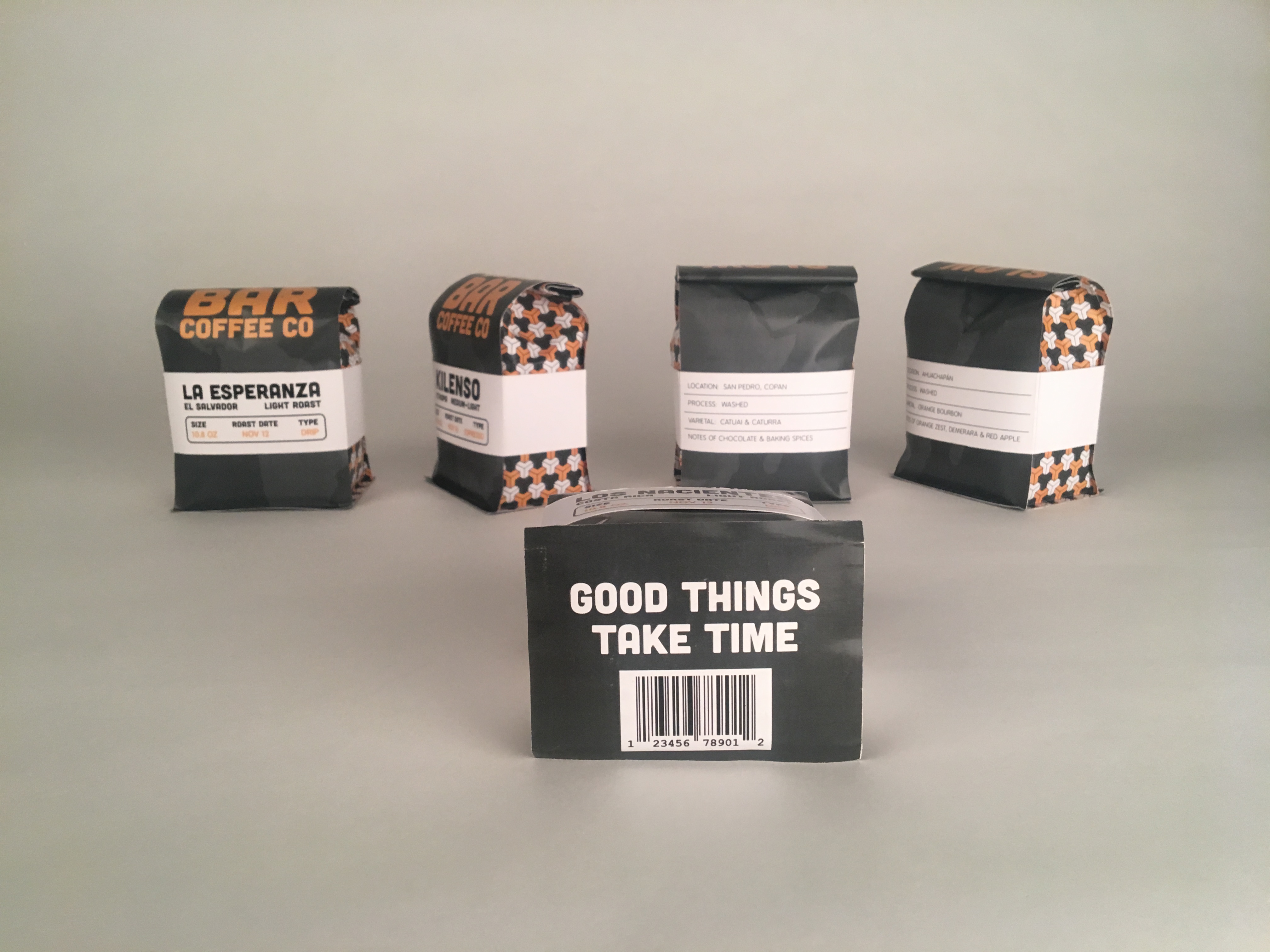 Multiple angles of coffee bags from Slow Bar Coffee Company.